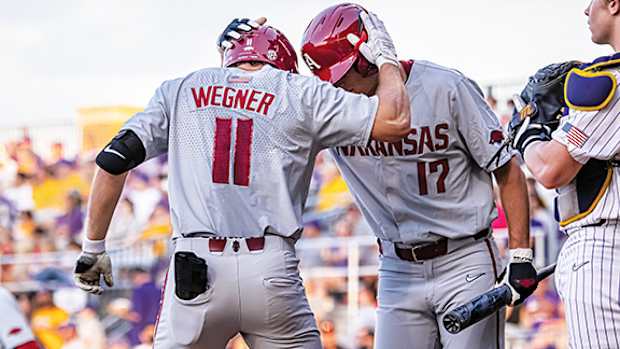Arkansas Razorback hitter Jared Wegner celebrates his home run with Brady Slavens.